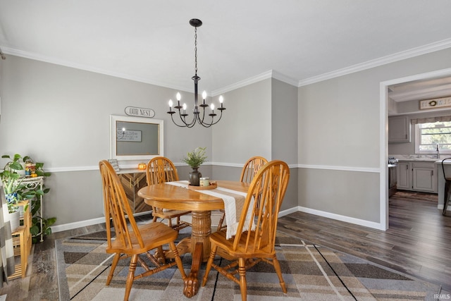 dining area with crown molding, dark hardwood / wood-style flooring, sink, and a notable chandelier