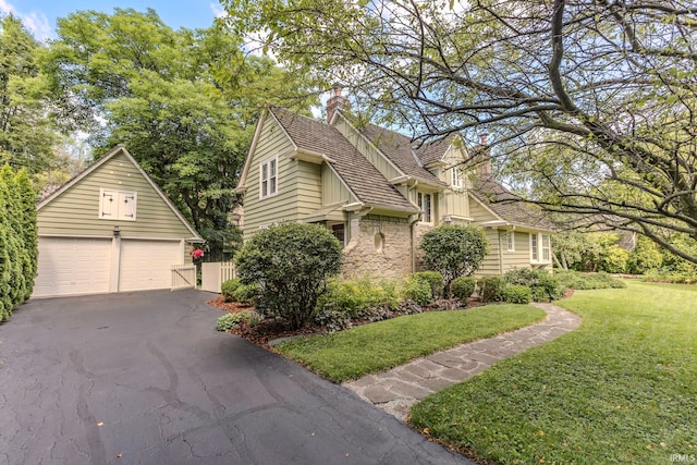 view of front of property with a front yard and a garage