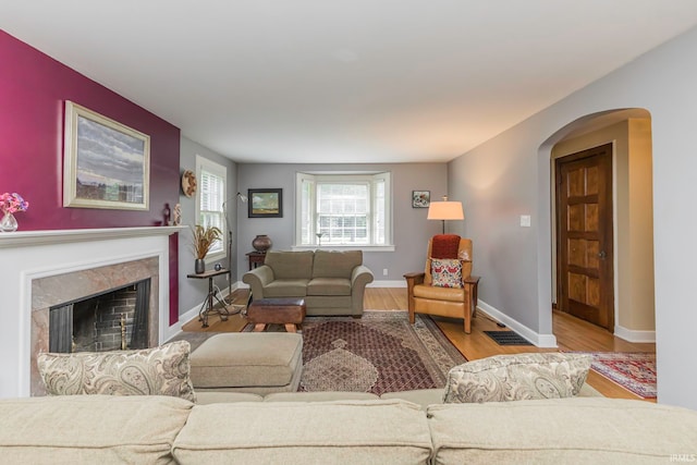 living room featuring light hardwood / wood-style floors and a premium fireplace