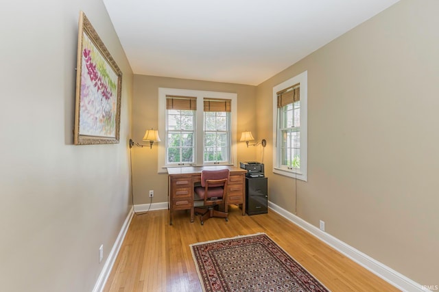 office with light wood-type flooring