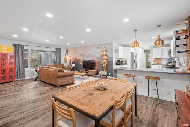 dining space with light hardwood / wood-style flooring