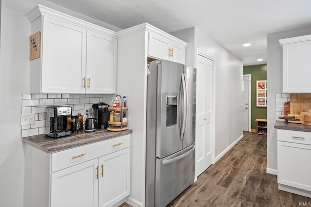 kitchen with stainless steel fridge with ice dispenser, dark hardwood / wood-style floors, white cabinetry, and tasteful backsplash