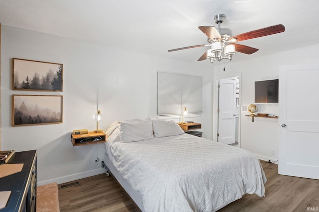 bedroom with ceiling fan and dark wood-type flooring