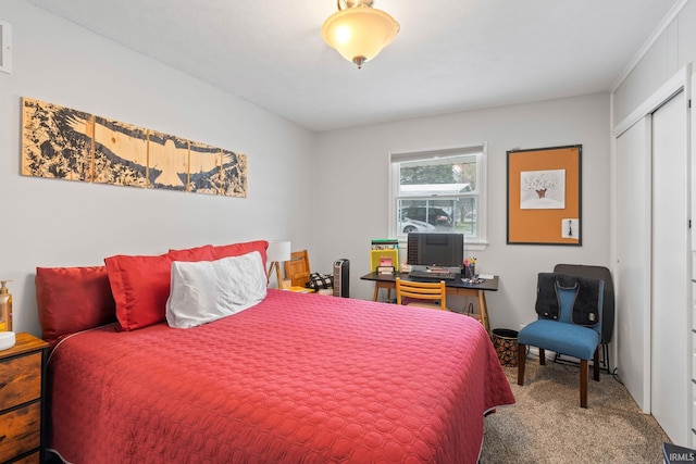 bedroom with carpet, a closet, and crown molding