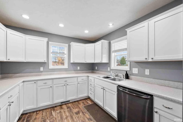 kitchen with white cabinets, stainless steel dishwasher, and sink