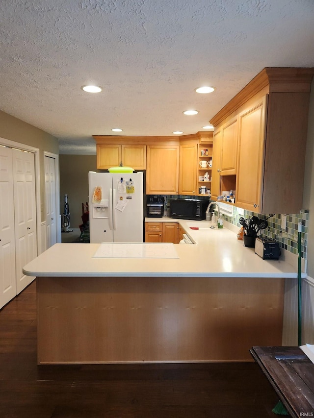 kitchen with decorative backsplash, white fridge with ice dispenser, light brown cabinetry, dark hardwood / wood-style flooring, and kitchen peninsula