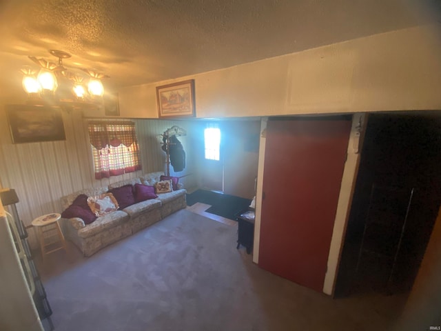 carpeted living room featuring a textured ceiling