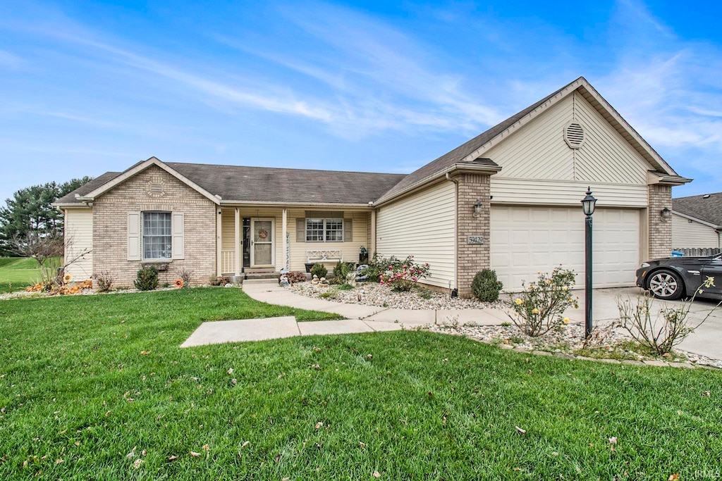 ranch-style house featuring a garage and a front yard