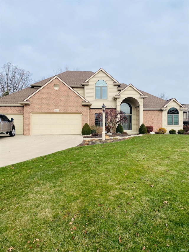 view of front of house with a front yard and a garage