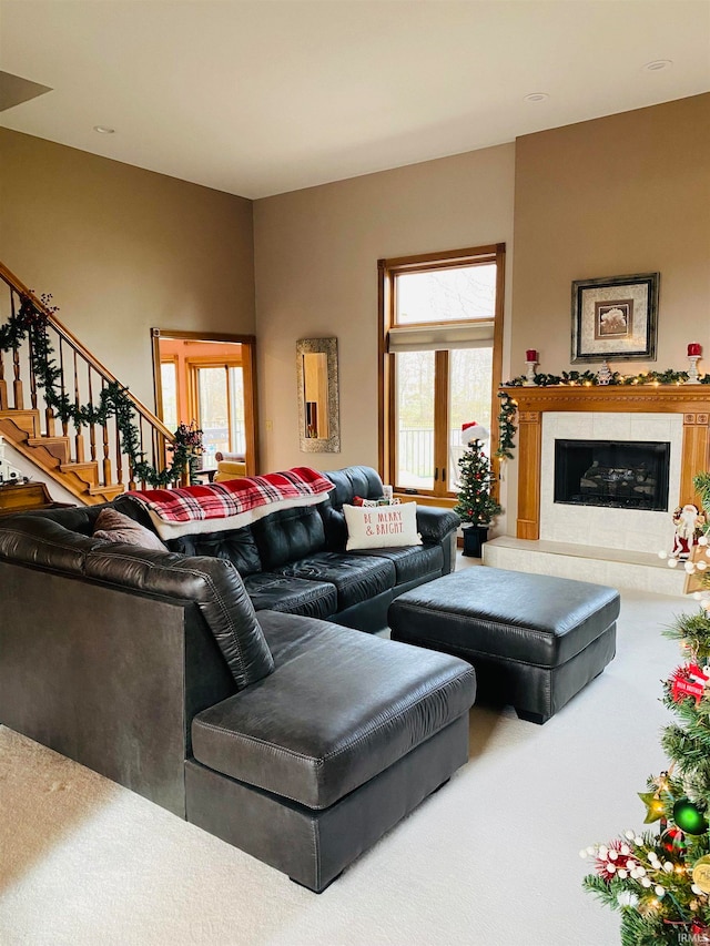 living room with a fireplace and carpet floors