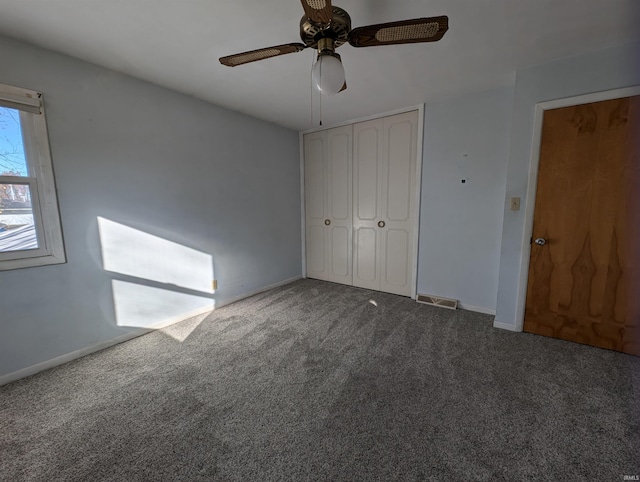 unfurnished bedroom with ceiling fan, a closet, and carpet floors