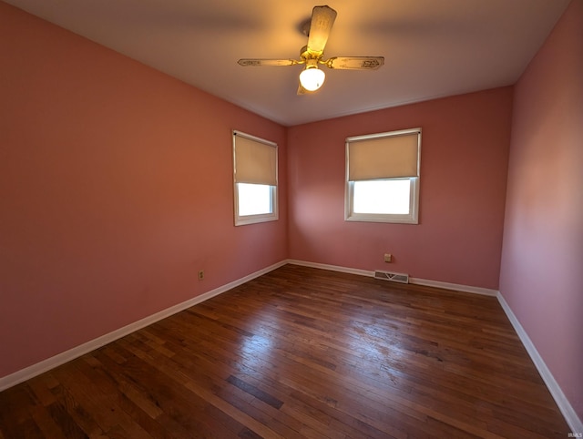 unfurnished room featuring dark hardwood / wood-style floors and ceiling fan