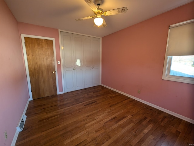 unfurnished bedroom with ceiling fan and dark hardwood / wood-style floors