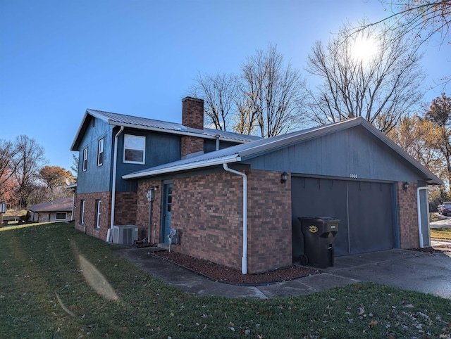 view of property exterior with central AC, a garage, and a lawn