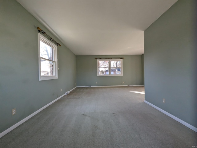 carpeted empty room with a healthy amount of sunlight