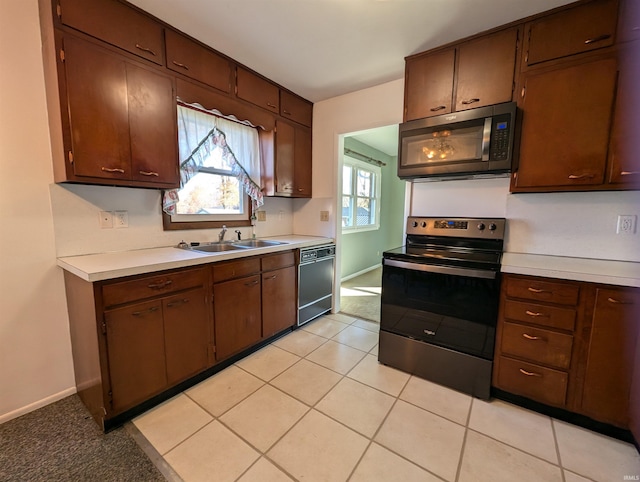 kitchen featuring dark brown cabinetry, dishwasher, sink, stainless steel range with electric stovetop, and light tile patterned floors