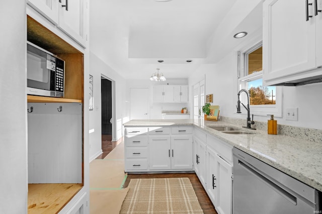 kitchen featuring white cabinetry, sink, stainless steel appliances, and hardwood / wood-style flooring