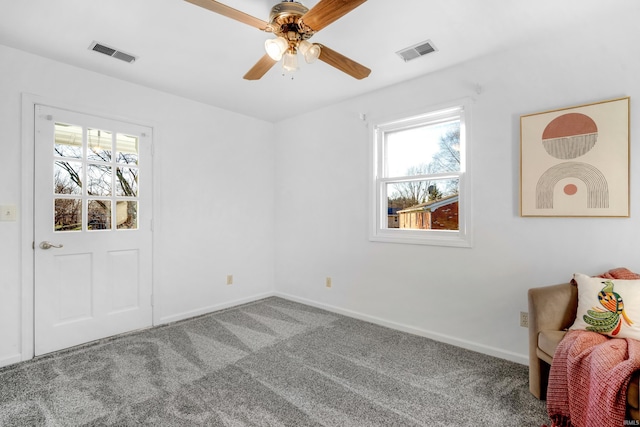 carpeted empty room featuring ceiling fan and a healthy amount of sunlight