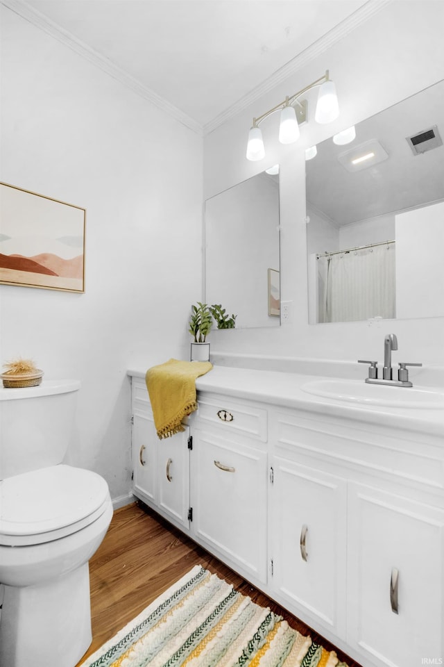 bathroom featuring crown molding, hardwood / wood-style floors, toilet, vanity, and a shower with shower curtain