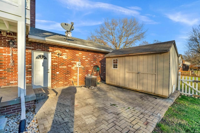 view of patio / terrace with central air condition unit and a storage unit