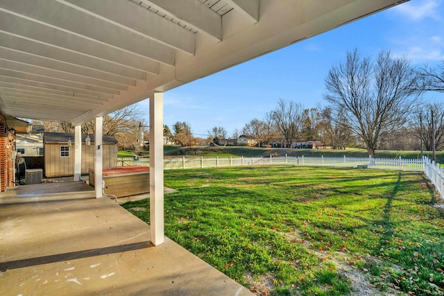 view of yard with central air condition unit, a patio, and a shed