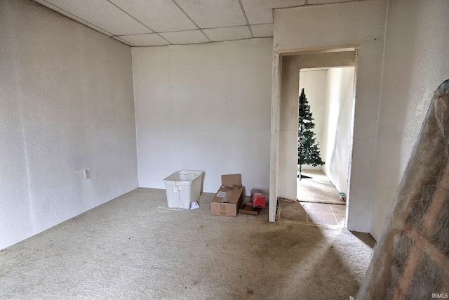 empty room featuring carpet flooring and a drop ceiling