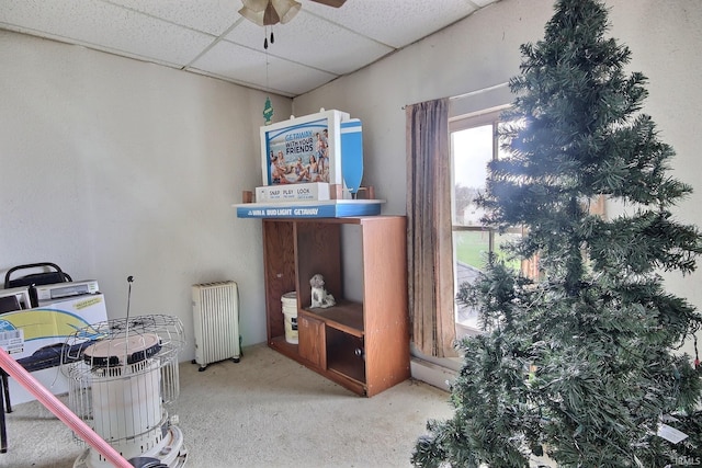 miscellaneous room featuring a paneled ceiling, ceiling fan, carpet flooring, and radiator