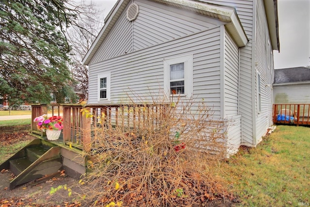 view of side of home with a wooden deck