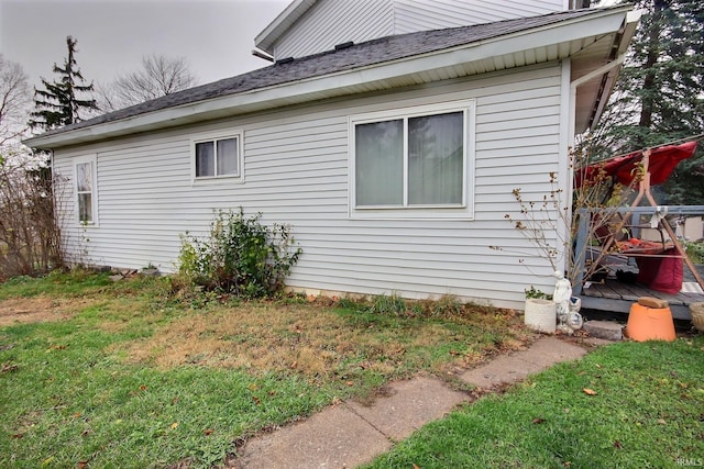 view of property exterior with a yard