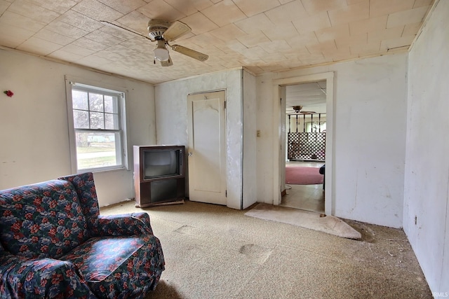 living area featuring ceiling fan and light colored carpet