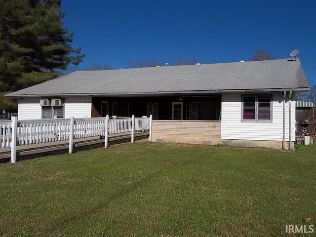 rear view of house featuring a yard