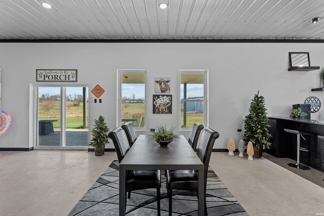 dining space featuring wooden ceiling, crown molding, and a healthy amount of sunlight