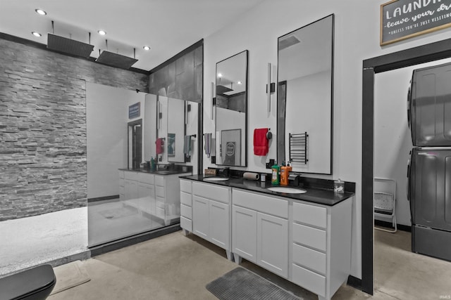 bathroom featuring vanity, walk in shower, and concrete floors