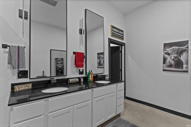 bathroom with vanity and concrete floors