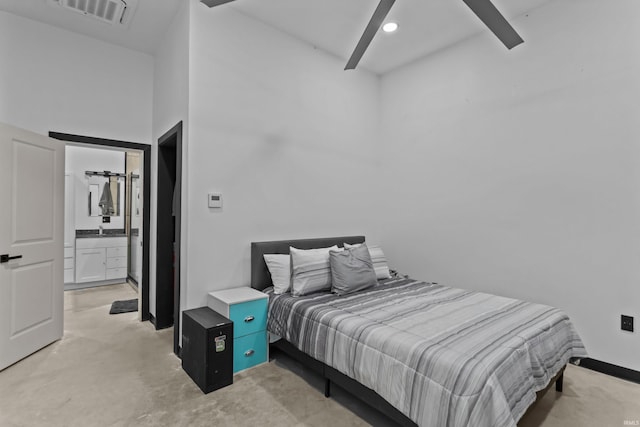 bedroom featuring ensuite bath and a towering ceiling