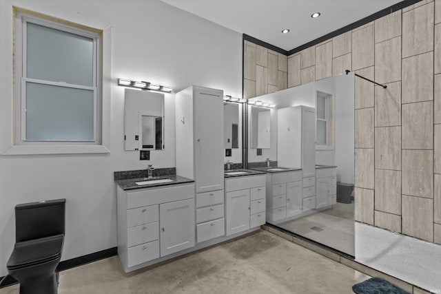 bathroom with vanity, walk in shower, and concrete floors