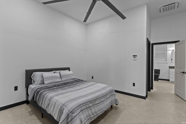 bedroom with connected bathroom, ceiling fan, and a high ceiling