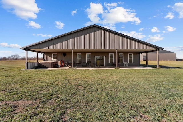 rear view of property featuring a patio and a lawn