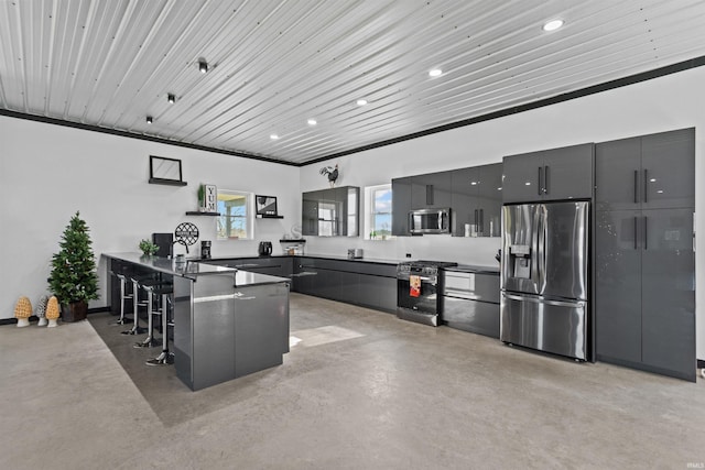 kitchen with a kitchen bar, kitchen peninsula, stainless steel appliances, and ornamental molding