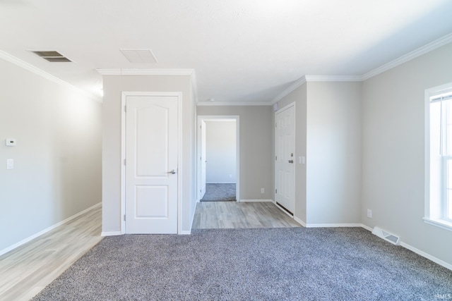 unfurnished room with crown molding and light wood-type flooring