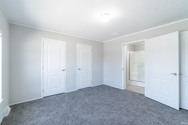 unfurnished bedroom featuring dark colored carpet and crown molding