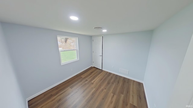 spare room featuring dark hardwood / wood-style flooring