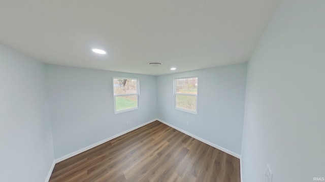 empty room with hardwood / wood-style floors