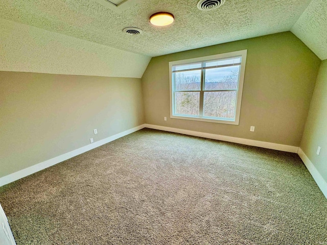 bonus room with carpet flooring, a textured ceiling, and lofted ceiling