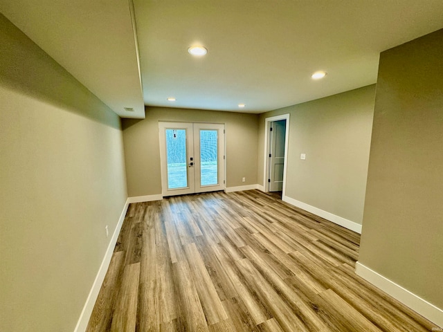 unfurnished room featuring french doors and light wood-type flooring