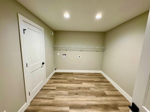 washroom with washer hookup, light hardwood / wood-style flooring, and electric dryer hookup