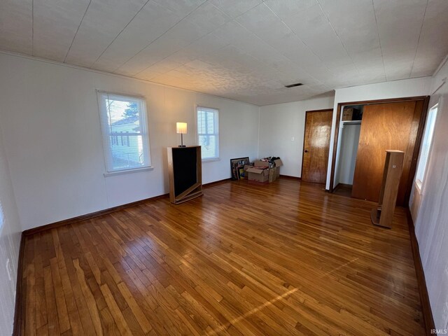 unfurnished living room featuring hardwood / wood-style floors