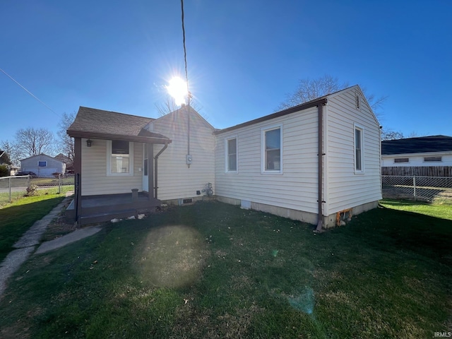 rear view of property with a lawn