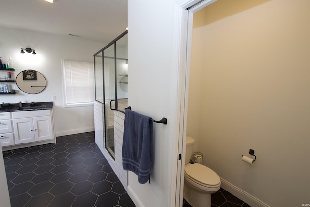 bathroom featuring tile patterned floors, vanity, an enclosed shower, and toilet