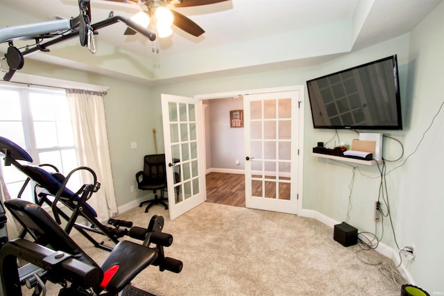 exercise room featuring ceiling fan, french doors, and light colored carpet